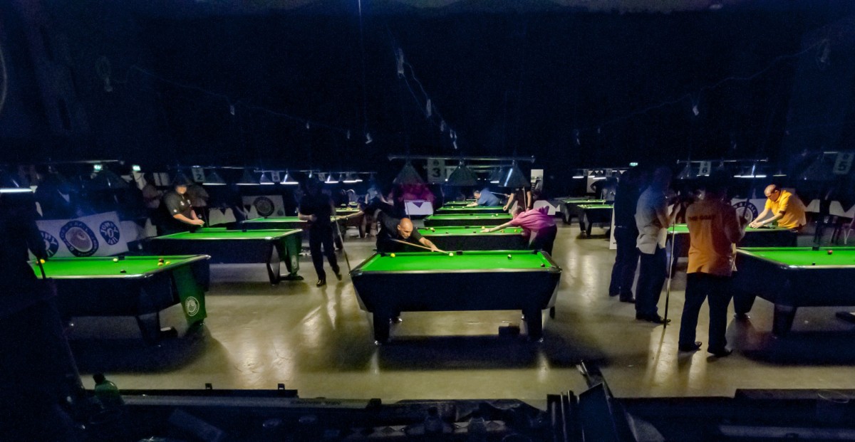The arena at night, tables lit and frames in play